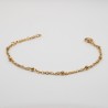 gouden bolletjes aan een medium geschakelde armbandje