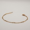 fijne gouden bolletjes aan een fijn geschakeld armbandje